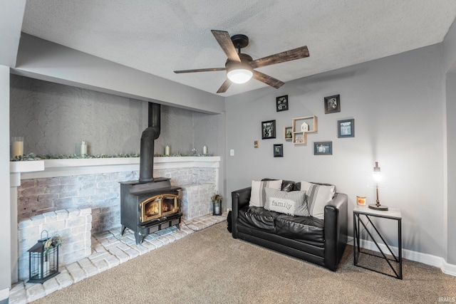 4618 Kekionga Dr, Fort Wayne, IN 46809 - carpeted living area featuring ceiling fan, a wood stove, and a textured ceiling