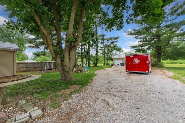 4618 Kekionga Dr, Fort Wayne, IN 46809 - view of yard featuring an outdoor structure and a garage
