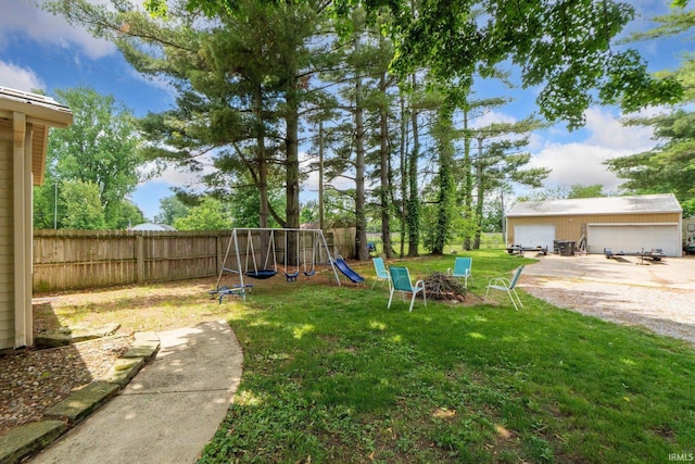 4618 Kekionga Dr, Fort Wayne, IN 46809 - view of yard featuring a playground, a garage, and an outdoor structure