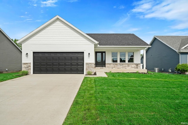416 Champery Dr, Osceola, IN 46561 - view of front of house featuring stone siding, a front yard, driveway, a garage, and roof with shingles