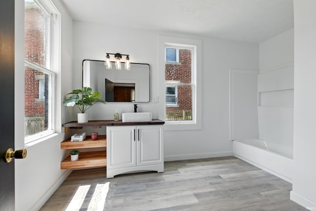 44 E Taylor St, Huntington, IN 46750 - full bath with vanity, wood finished floors, a tub to relax in, and healthy amount of natural light