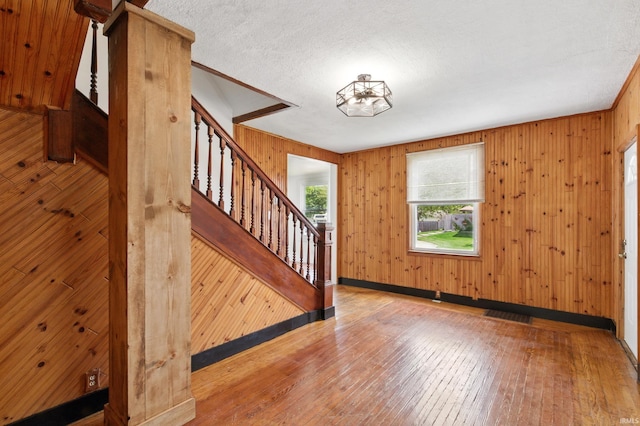44 E Taylor St, Huntington, IN 46750 - foyer entrance featuring stairway, wood-type flooring, wooden walls, and baseboards