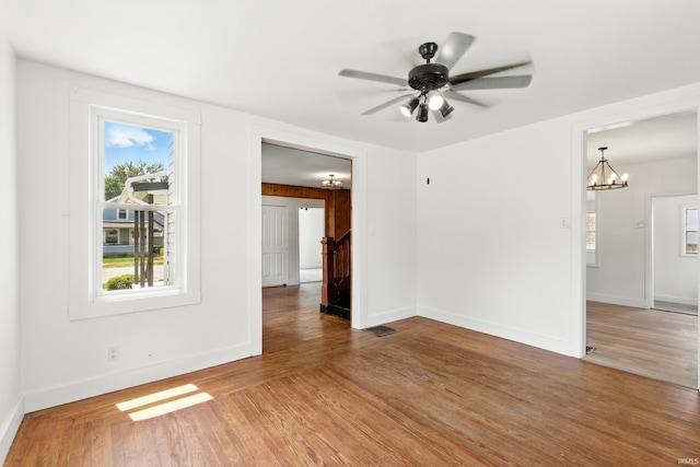 44 E Taylor St, Huntington, IN 46750 - unfurnished room with a chandelier, wood finished floors, ceiling fan, and baseboards