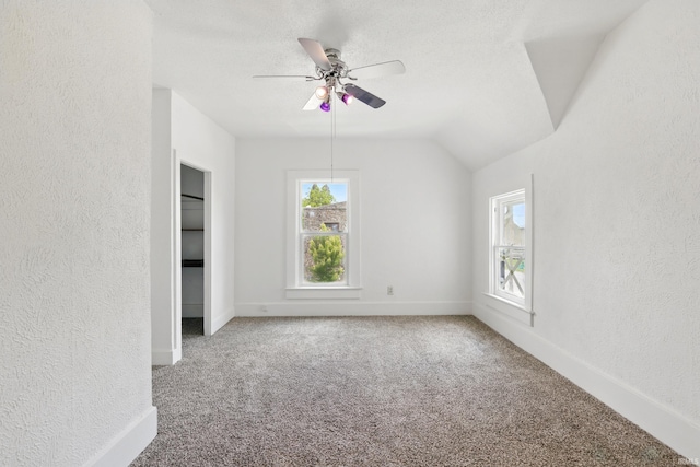 44 E Taylor St, Huntington, IN 46750 - carpeted spare room featuring a textured wall, ceiling fan, baseboards, and vaulted ceiling