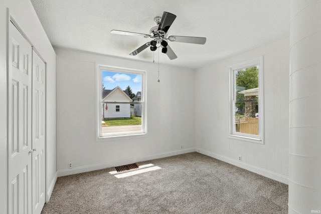 44 E Taylor St, Huntington, IN 46750 - unfurnished bedroom with carpet, baseboards, a closet, and a ceiling fan