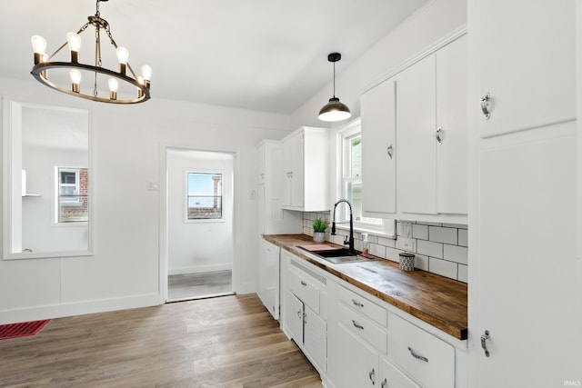 44 E Taylor St, Huntington, IN 46750 - kitchen with wooden counters, a sink, white cabinets, backsplash, and a chandelier