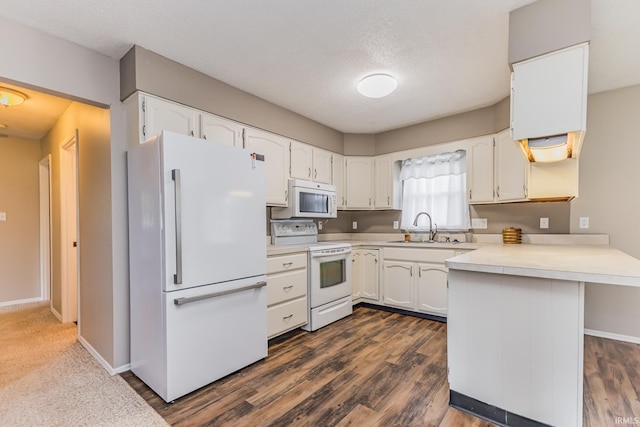 3608 W 31st St, Muncie, IN 47302 - kitchen with white appliances, a sink, a peninsula, white cabinets, and a textured ceiling