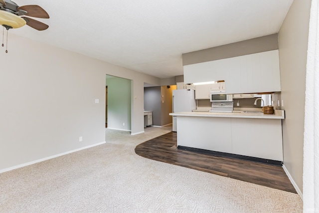 3608 W 31st St, Muncie, IN 47302 - kitchen with white appliances, ceiling fan, a sink, light countertops, and carpet