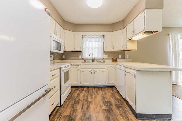 3608 W 31st St, Muncie, IN 47302 - kitchen featuring white appliances, a sink, a peninsula, dark wood-style flooring, and a textured ceiling