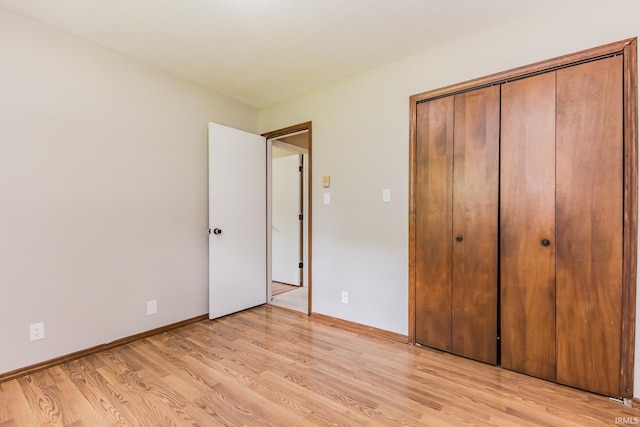 3608 W 31st St, Muncie, IN 47302 - unfurnished bedroom with light wood-type flooring, a closet, and baseboards