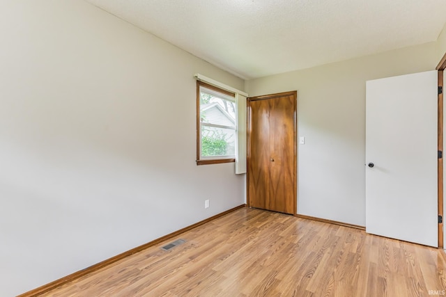 3608 W 31st St, Muncie, IN 47302 - unfurnished bedroom with light wood-style floors, baseboards, and a closet