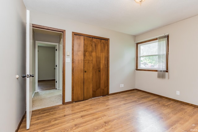 3608 W 31st St, Muncie, IN 47302 - unfurnished bedroom featuring light wood-type flooring, a closet, and baseboards