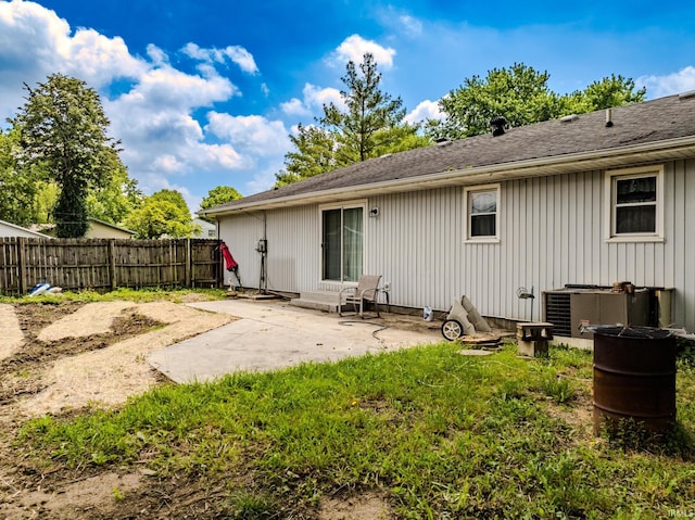 3608 W 31st St, Muncie, IN 47302 - rear view of house featuring a patio, cooling unit, and roof with shingles