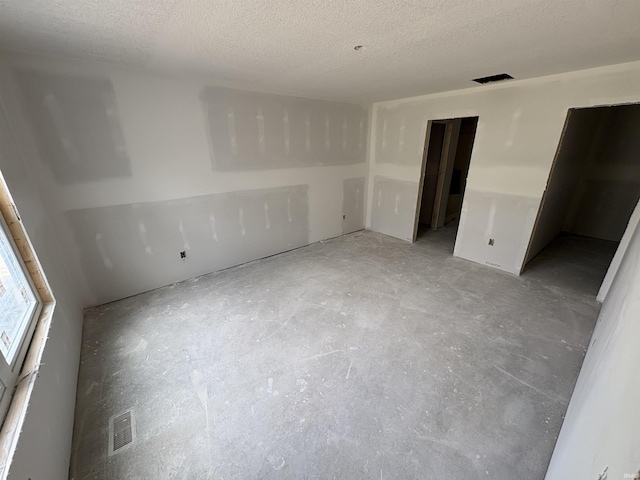 4792 Falcon Pkwy, New Haven, IN 46774 - spare room featuring unfinished concrete flooring and a textured ceiling