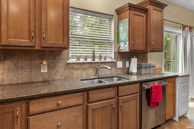 4665 S 150 E, Lafayette, IN 47909 - kitchen featuring dishwasher, a sink, brown cabinets, dark stone countertops, and decorative backsplash