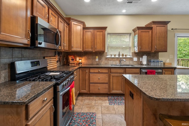 4665 S 150 E, Lafayette, IN 47909 - kitchen with appliances with stainless steel finishes, a sink, brown cabinetry, recessed lighting, and decorative backsplash