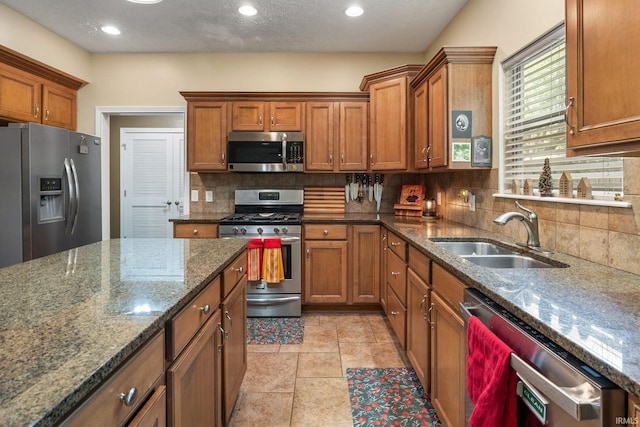 4665 S 150 E, Lafayette, IN 47909 - kitchen featuring stainless steel appliances, a sink, brown cabinets, and recessed lighting
