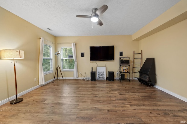 4665 S 150 E, Lafayette, IN 47909 - unfurnished living room with a textured ceiling, ceiling fan, wood finished floors, and baseboards