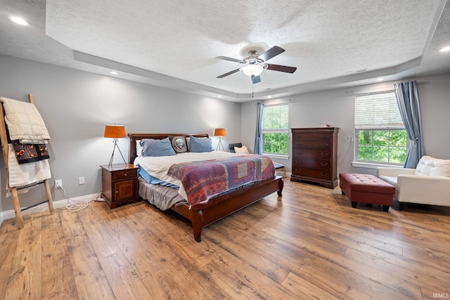 4665 S 150 E, Lafayette, IN 47909 - bedroom with a textured ceiling, a raised ceiling, light wood finished floors, baseboards, and ceiling fan
