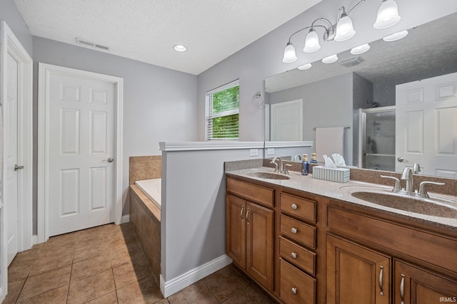 4665 S 150 E, Lafayette, IN 47909 - bathroom featuring a stall shower, a textured ceiling, double vanity, a garden tub, and tile patterned floors