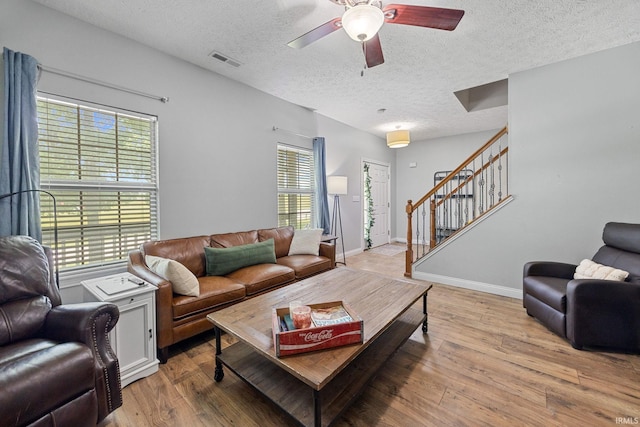 4665 S 150 E, Lafayette, IN 47909 - living room with a textured ceiling, stairs, light wood-style floors, a ceiling fan, and baseboards