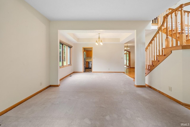 56 Jester Ct, Lafayette, IN 47905 - unfurnished living room with a chandelier, carpet floors, baseboards, and stairway