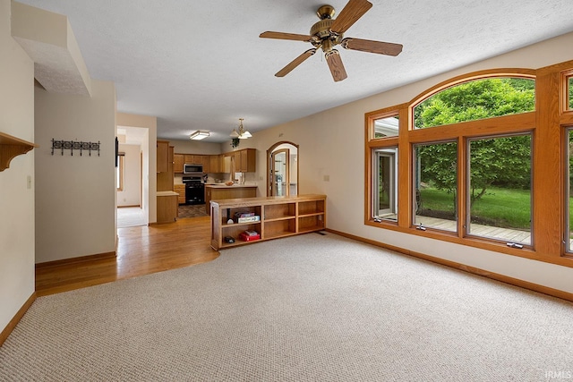 56 Jester Ct, Lafayette, IN 47905 - living area featuring light colored carpet, baseboards, and a ceiling fan