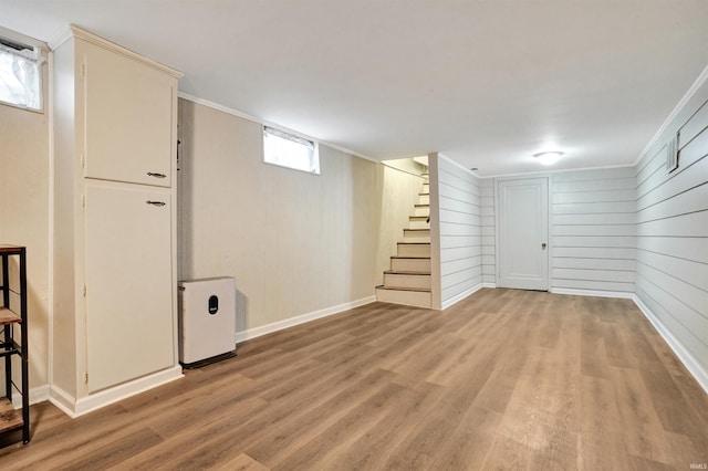 2012 Clayton Ave, Evansville, IN 47715 - basement featuring light wood finished floors, stairs, baseboards, crown molding, and wooden walls