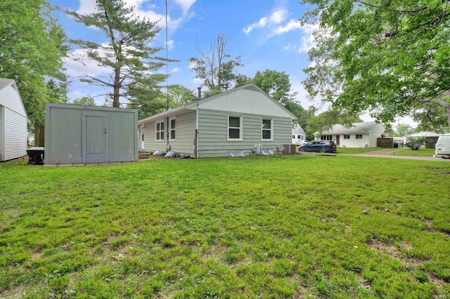 2012 Clayton Ave, Evansville, IN 47715 - rear view of property with a lawn and central AC unit