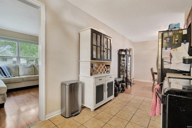 2012 Clayton Ave, Evansville, IN 47715 - kitchen featuring range, light countertops, glass insert cabinets, and baseboards