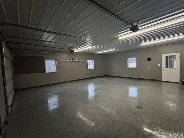 1230 S Iron Mountain Rd, Bloomfield, IN 47424 - garage with a garage door opener and baseboards