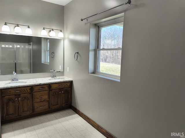 1230 S Iron Mountain Rd, Bloomfield, IN 47424 - bathroom featuring double vanity, plenty of natural light, baseboards, and tile patterned flooring