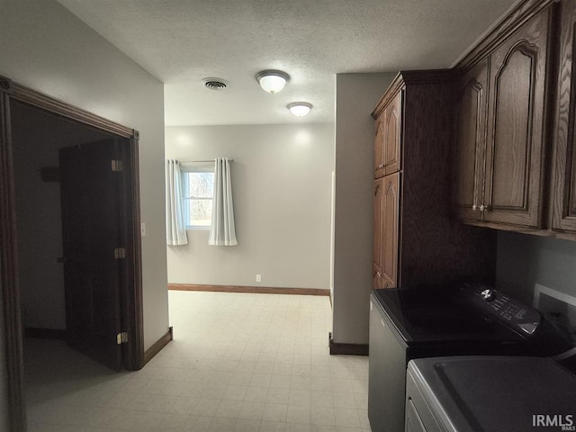 1230 S Iron Mountain Rd, Bloomfield, IN 47424 - laundry area with cabinet space, washer and clothes dryer, baseboards, light floors, and a textured ceiling