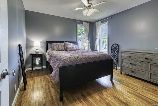 11871 N Wayne St, Zanesville, IN 46799 - bedroom with wood-type flooring, baseboards, and ceiling fan