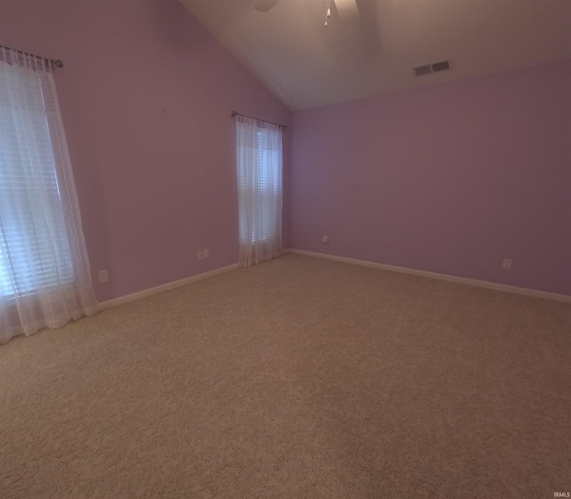 3408 Fox Ct, Evansville, IN 47711 - empty room featuring light colored carpet, vaulted ceiling, a ceiling fan, and healthy amount of natural light