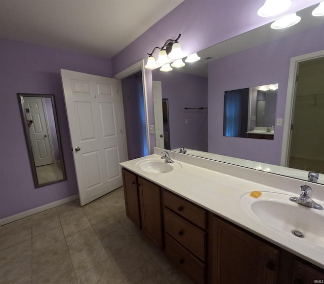 3408 Fox Ct, Evansville, IN 47711 - bathroom with double vanity, tile patterned flooring, baseboards, and a closet