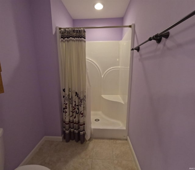 3408 Fox Ct, Evansville, IN 47711 - bathroom with a shower with shower curtain, toilet, tile patterned flooring, and baseboards