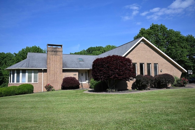 1029 S University Dr, Jasper, IN 47546 - single story home with brick siding, a front lawn, and a chimney