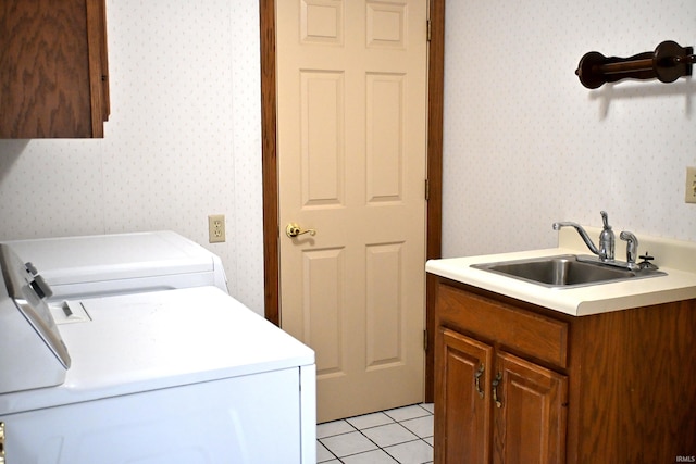 1029 S University Dr, Jasper, IN 47546 - washroom featuring washer and clothes dryer, wallpapered walls, cabinet space, and light tile patterned floors