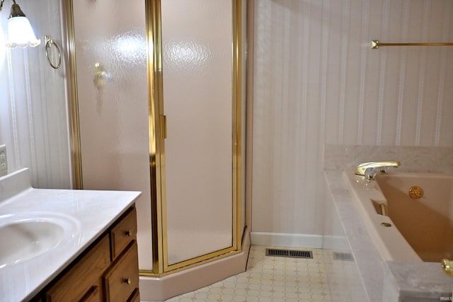 1029 S University Dr, Jasper, IN 47546 - bathroom with a shower stall, vanity, a tub with jets, and baseboards