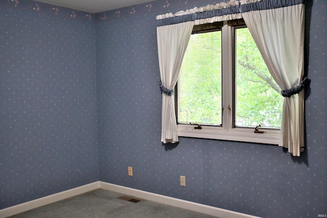 1029 S University Dr, Jasper, IN 47546 - carpeted empty room with healthy amount of natural light, baseboards, and wallpapered walls