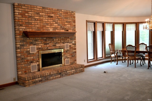 1029 S University Dr, Jasper, IN 47546 - living room featuring carpet flooring, a fireplace, a chandelier, and baseboards