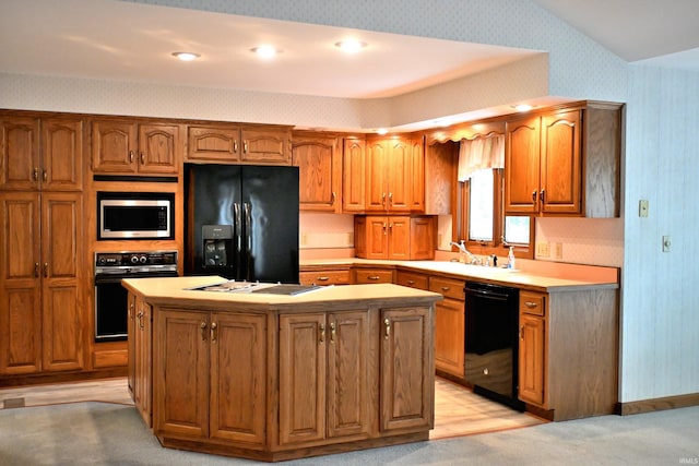 1029 S University Dr, Jasper, IN 47546 - kitchen with black appliances, wallpapered walls, a sink, a center island, and brown cabinetry