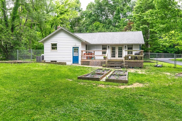 5889 E 46th Rd, Bloomington, IN 47408 - rear view of house featuring french doors, a vegetable garden, a deck, central AC unit, and crawl space
