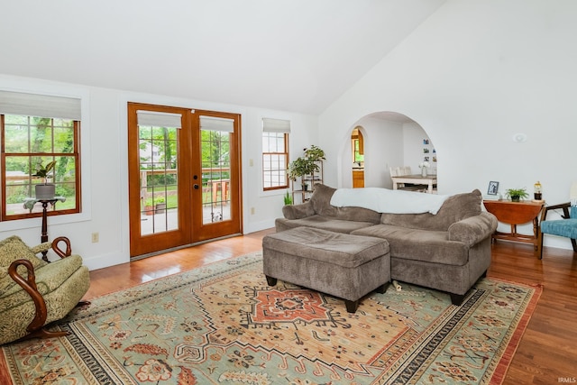5889 E 46th Rd, Bloomington, IN 47408 - living area with french doors, wood finished floors, lofted ceiling, and arched walkways