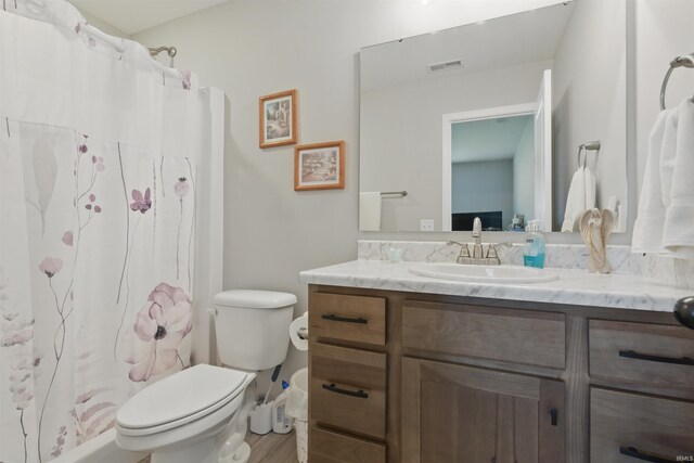 3436 Fawn Creek Blvd, Waterloo, IN 46793 - full bathroom with vanity, toilet, a shower with shower curtain, and wood finished floors