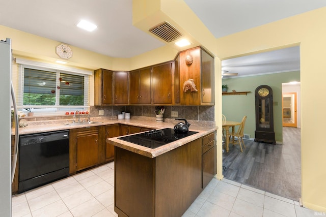 4112 Hiawatha Blvd, Fort Wayne, IN 46809 - kitchen with black appliances, a sink, light tile patterned flooring, a peninsula, and decorative backsplash