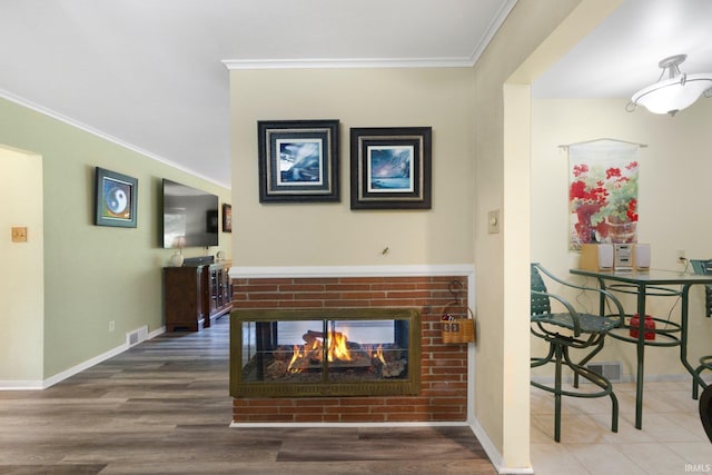 4112 Hiawatha Blvd, Fort Wayne, IN 46809 - living area featuring a brick fireplace, crown molding, baseboards, and wood finished floors