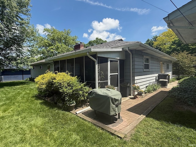 4112 Hiawatha Blvd, Fort Wayne, IN 46809 - back of property featuring a yard, a chimney, and a sunroom