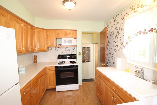19511 Eaton Ave, South Bend, IN 46637 - kitchen with white appliances, healthy amount of natural light, light countertops, and a sink